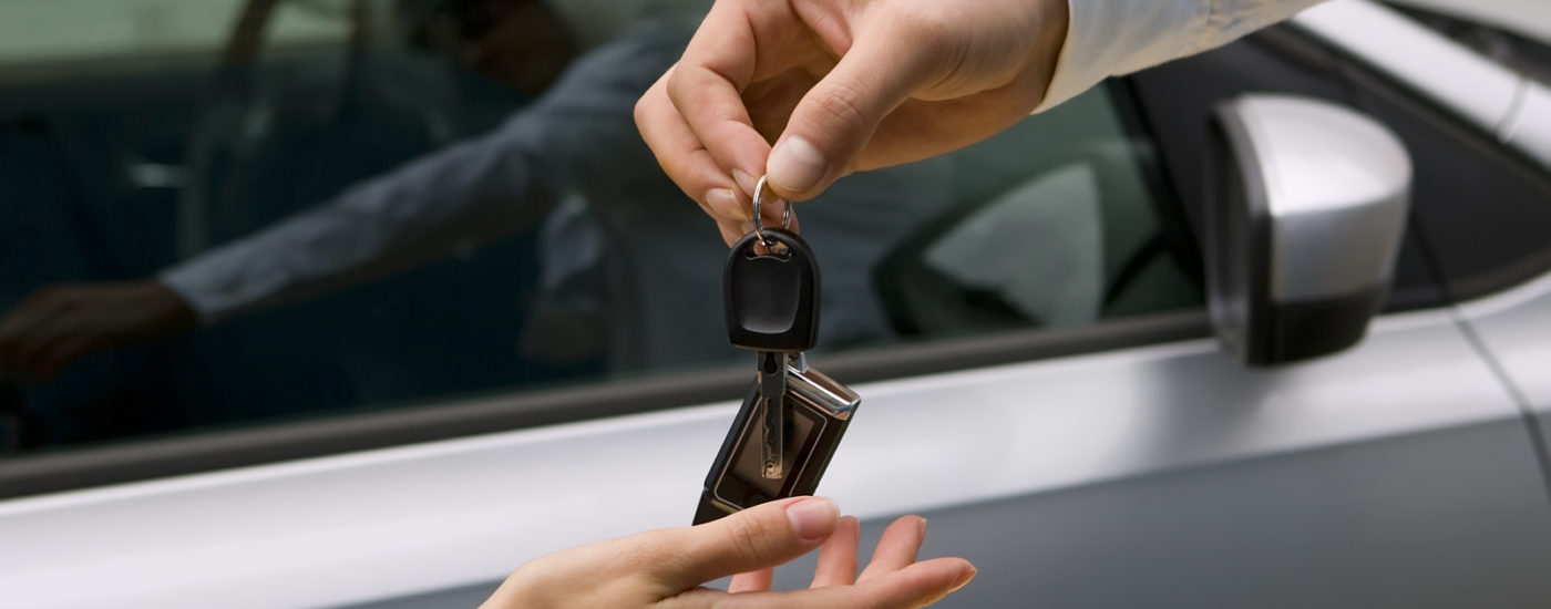 woman receiving car key from man