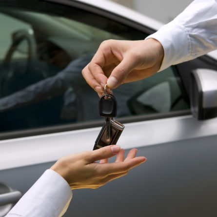 woman receiving car key from man